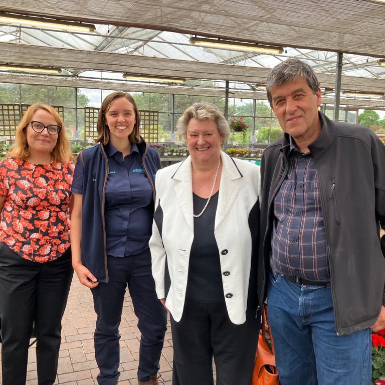 L-R Jennifer Pheasey from the HTA, Laura Jackson, Heather Wheeler MP and John Jackson standing in a garden centre surrounded by plants