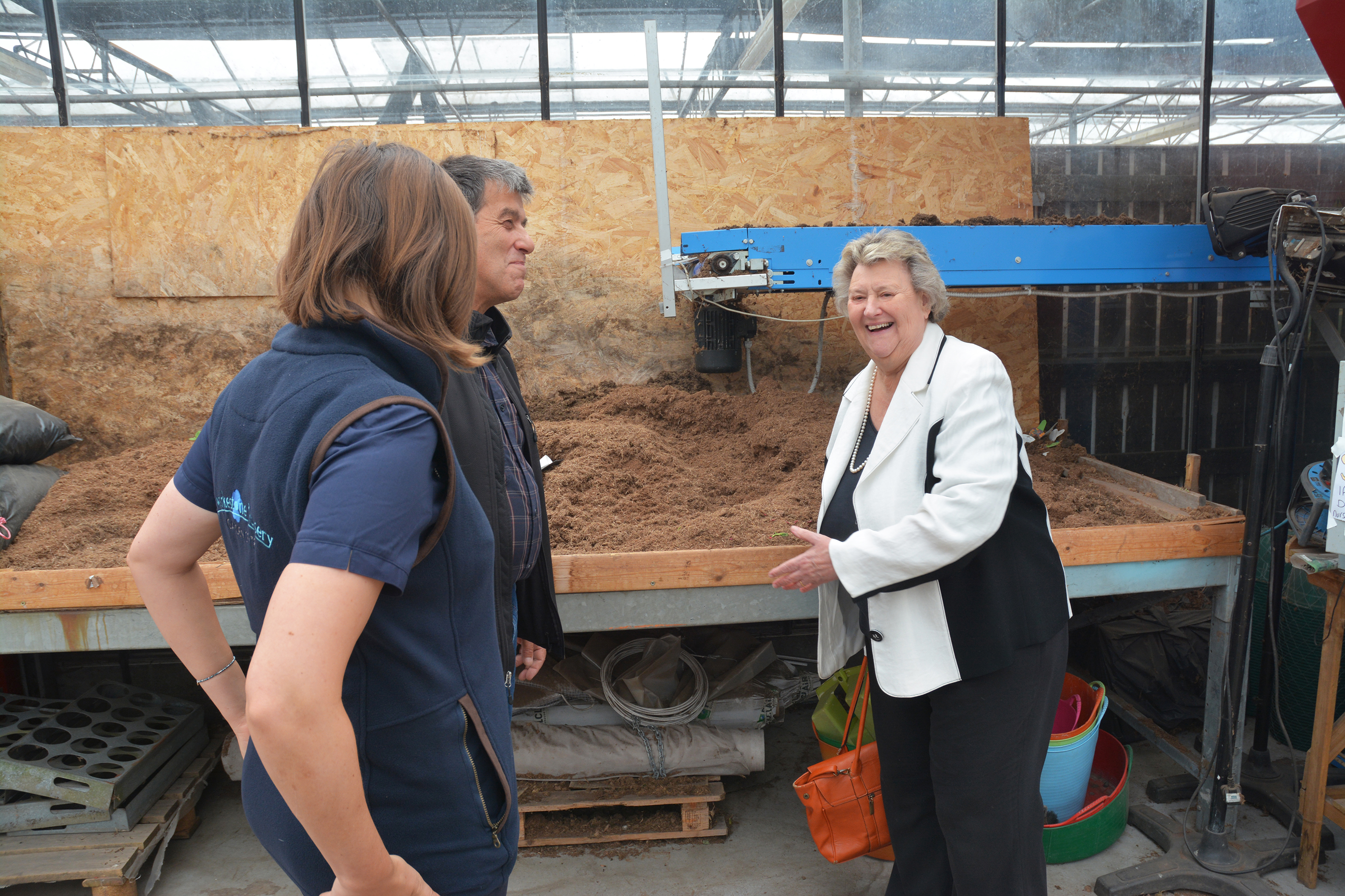 L-R Laura and John Jackson from Swarkestone Nursery and Garden Centre with Heather Wheeler MP discussing growing media which can be seen in the background